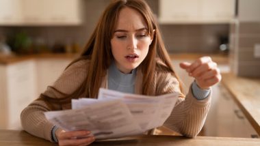 Woman Shocked by High Bills in Kitchen