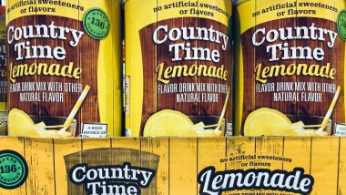 Large containers of Country Time Lemonade powdered drink mix for sale on a Costco Warehouse wholesale shelf.